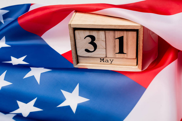 Wooden calendar with 31 may date on american flag  - Φωτογραφία, εικόνα