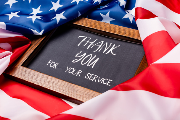 Chalkboard with thank you for your service lettering on american flag  - Photo, Image