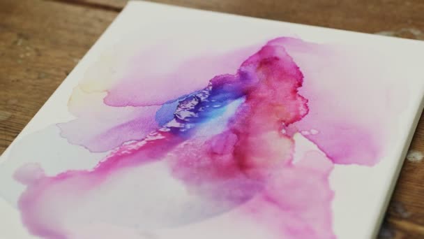 Fluid Art. Abstract colorful painting. Close up of artist uses dryer to blow on paints to make Fluid Art picture - Footage, Video