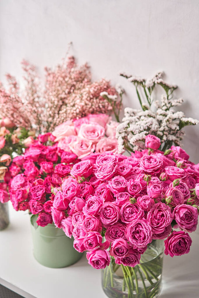 Set of white, pink and magenta flowers for Interior decorations. The work of the florist at a flower shop. Fresh cut flower. - Photo, Image