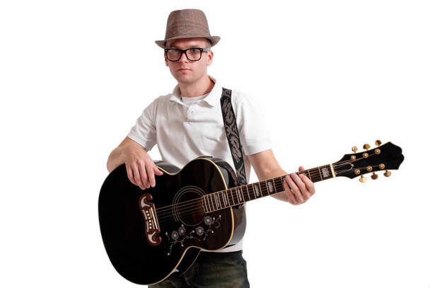 Musician in fedora with guitar. - 写真・画像