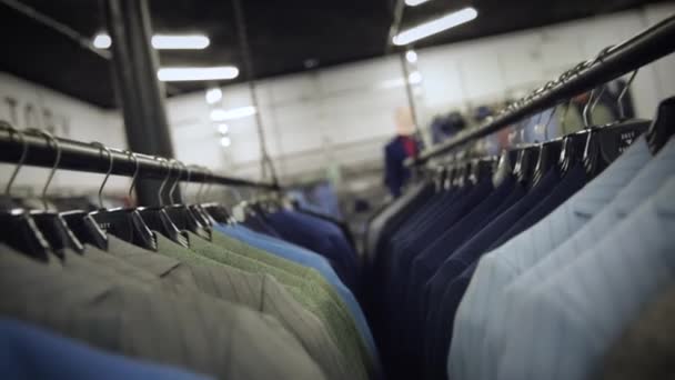 Slide through suits hanged on hangers - Footage, Video