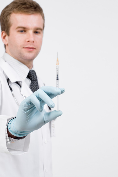 Professional doctor with medical syringe in hands - Zdjęcie, obraz