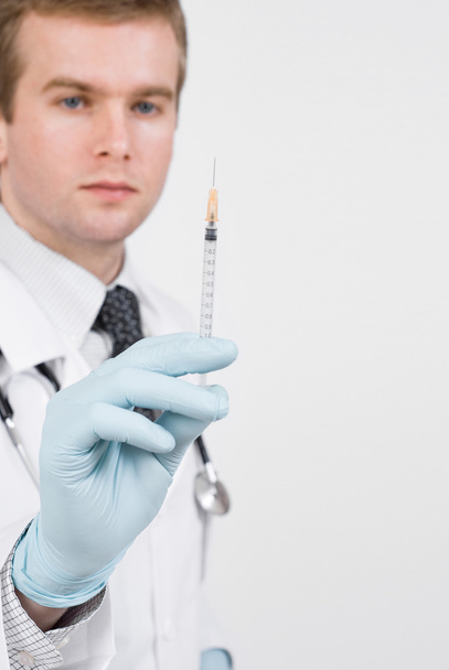 Doctor with medical syringe in hand ready to make injection - Foto, immagini