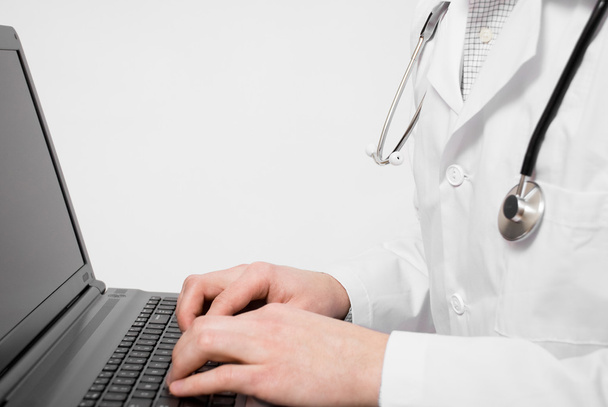 Doctor doing some work on laptop - Photo, Image