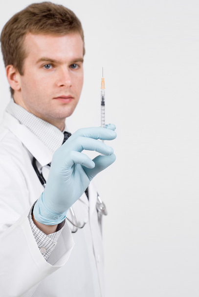 Doctor with medical syringe in hand ready to make injection - Photo, image