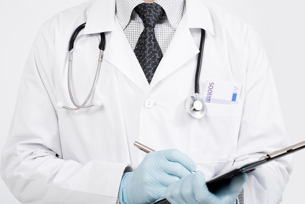 Medical doctor with clip board in hands - Фото, зображення