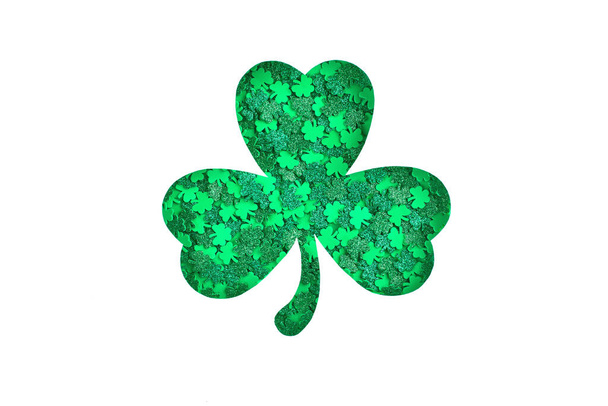 Shamrock silhouette with green confetti texture on white background - Photo, Image