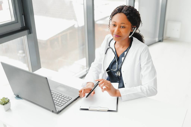 Telehealth, African American doctor in headset consulting with the patient over the phone call. Health care call center and telehealth online concept - Foto, Bild