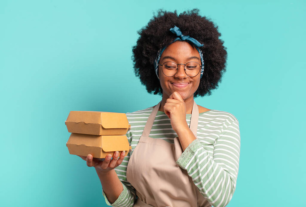 young pretty afro deliver woman with a take away burger boxes - Foto, imagen