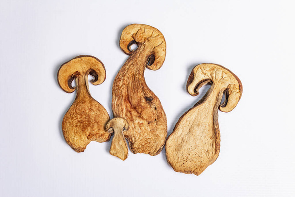 Dried mushrooms Boletus edulis (Penny bun, Cep, Porcini) isolated on white background. Ingredient for vegetarian (vegan) healthy food - Photo, Image