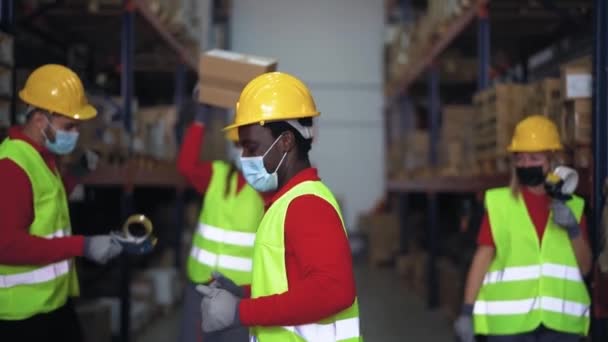 Multiracial team having fun dancing inside warehouse while wearing face mask during corona virus outbreak - Logistic and industrial concept - Footage, Video