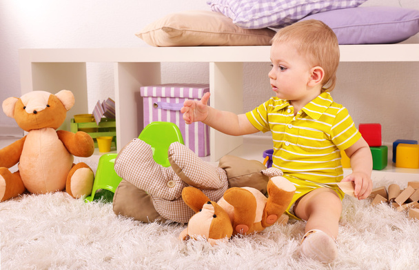 Cute little boy with wooden toy blocks in room - Fotoğraf, Görsel