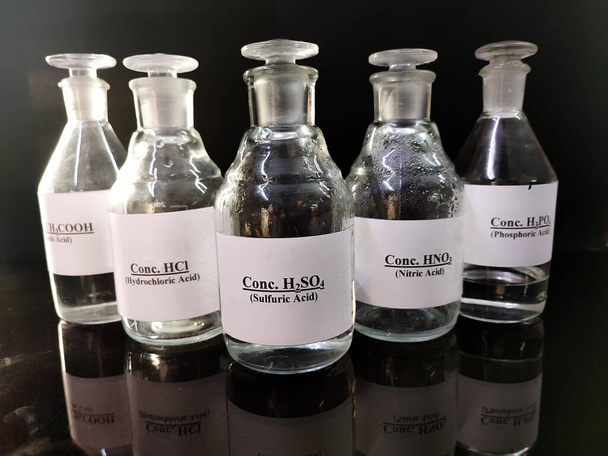 transparent bottles filled with concentrated acid - Photo, Image