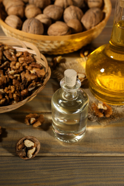 Walnut oil and nuts on wooden table - 写真・画像
