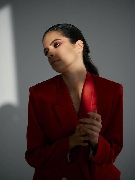 brunette in red jacket glance aside glamor cosmetics luxury - Фото, зображення