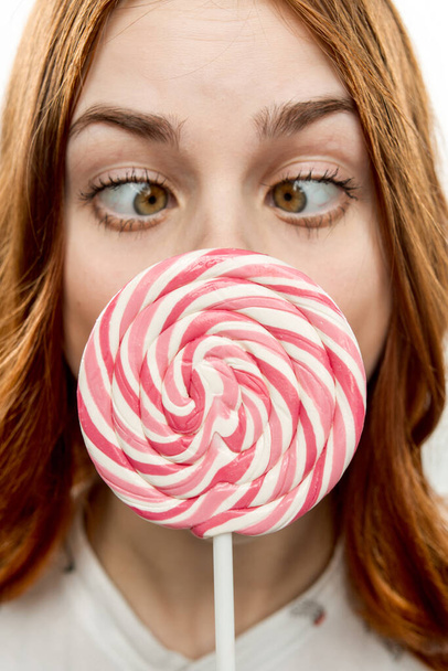 woman with open mouth holds lollipop near face Sweets joy  - Φωτογραφία, εικόνα