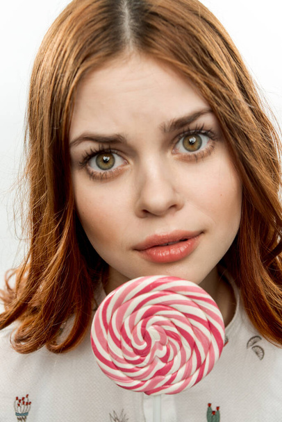 pretty woman licks round lollipop delight dessert sweets - Φωτογραφία, εικόνα