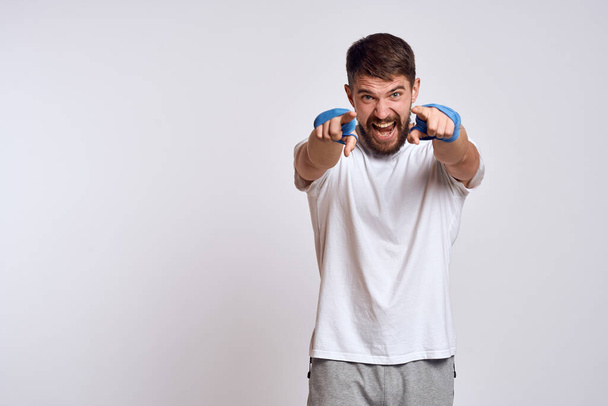 Sports man boxing bandages on hands emotions energy workout - Photo, Image