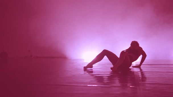 Sensual erotic dancing into smoke on dance floor - Foto, Bild