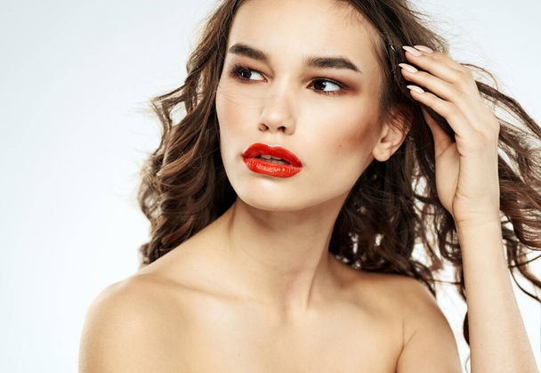 Woman model red lips eyeshadows bared shoulders portrait cropped view - Photo, Image