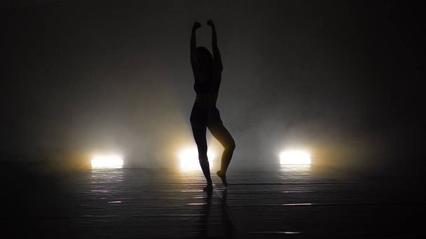 Young beautiful contemporary  ballerina on smoke stage dancing modern ballet - Photo, Image