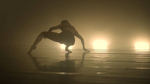 Ballerina in modern costume dancing sensually on scene - Valokuva, kuva