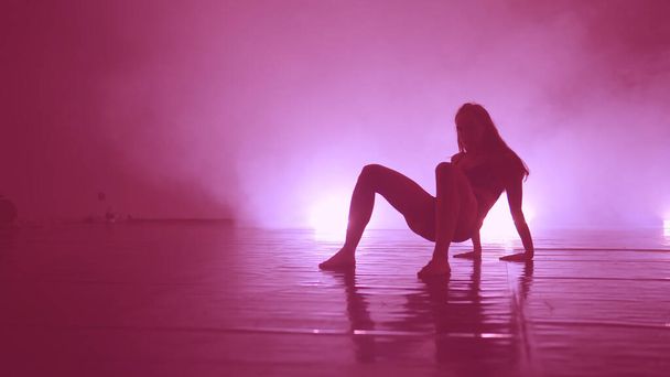 Sensual erotic dancing into smoke on dance floor - Zdjęcie, obraz