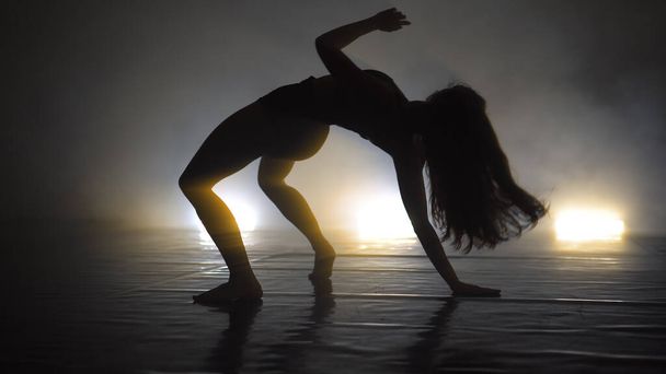 Sexy woman dancing modern ballet and contemporary choreography concept iin dark stydio with lights - Fotó, kép