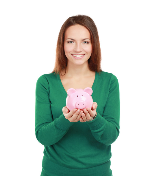Woman standing with piggy bank - Fotoğraf, Görsel