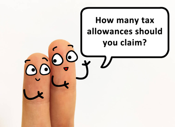 Two fingers are decorated as two person. One of them is asking how many tax allowances should he claim. - Photo, Image
