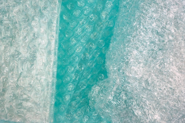 Air bubble wrap of different density and color top view. Green bubble wrap texture, background.  - Photo, Image