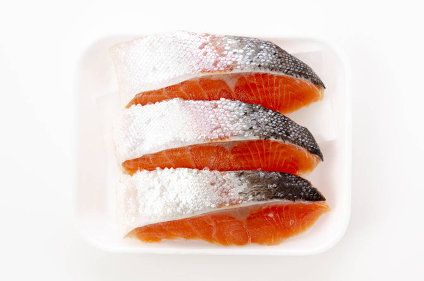 Raw fillet trout salmon in foam tray on white background - Photo, Image