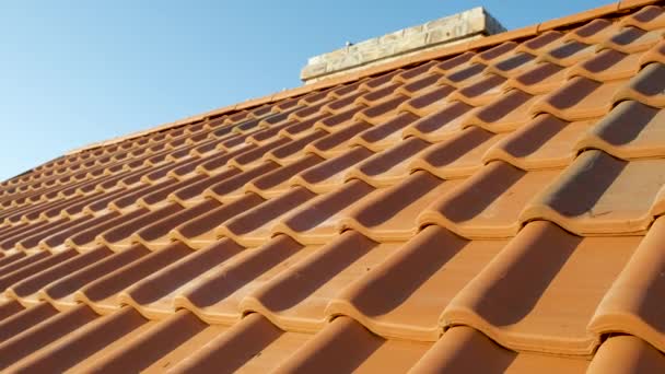 Overlapping rows of yellow ceramic roofing tiles covering residential building roof. - Footage, Video