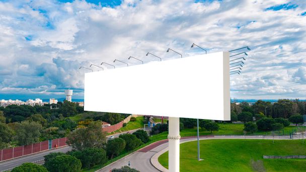 Blank billboard ready to use for mockup advertisement on the background of the city. Billboard white blank with room to add your own text. Retail, outdoor advertisement and commerce concept - Photo, Image