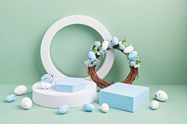 Podium, stand for product presentation and easter wreath with eggs. Mockup for branding and festive packaging presentation - Photo, Image