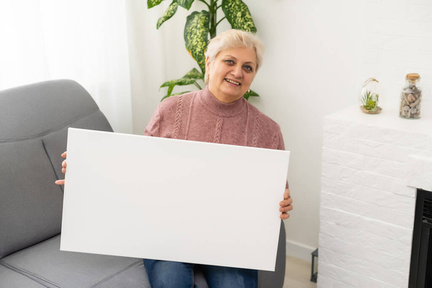 femme âgée tient une toile photo - Photo, image