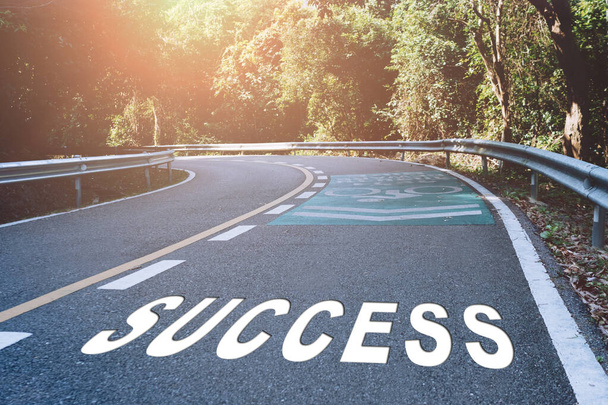 Success word on road in wood represents the beginning of a journey to the destination in business planning, strategy and challenge or career path, opportunity concept. - Photo, Image