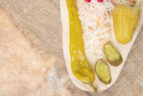 pickled vegetables and marinated cabbage served on plate - Photo, image