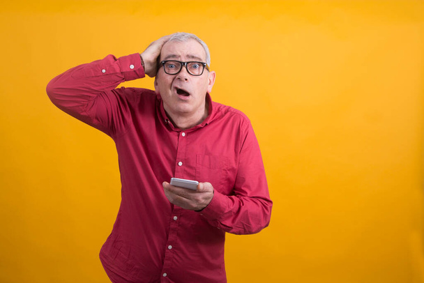 surprised or overwhelmed man with mobile phone - Foto, imagen