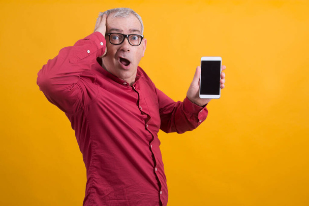 surprised or overwhelmed man with mobile phone - Fotografie, Obrázek