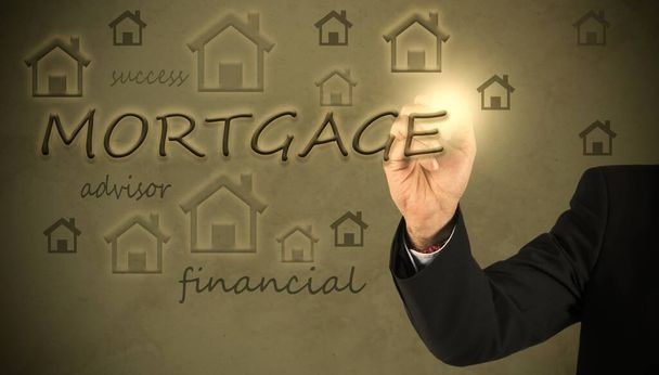 businessman with a pen writing about mortgages. mortgage and business concept - Foto, imagen