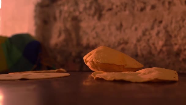 Handmade tortillas puffing up on hot black surface - Footage, Video