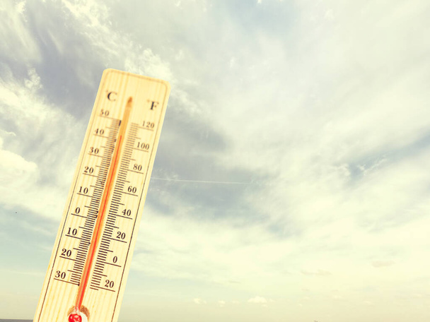 Heat, thermometer shows the temperature is hot in the sky, Summer Stock  Photo