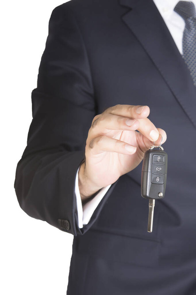 Cropped section of businessman with car key in hand, isolated on white background. - Valokuva, kuva