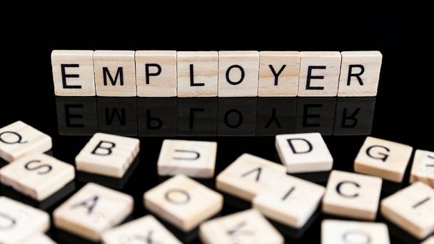 EMPLOYER text made of wooden letters on black background  - Photo, Image