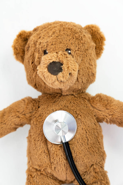 Teddy bear and stethoscope on a white background - Photo, Image