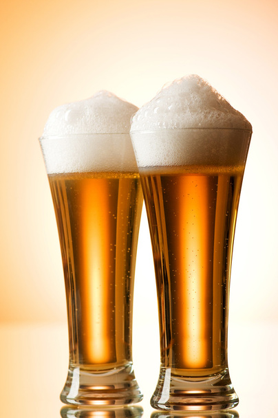 Beer glasses against the colorful gradient background - Photo, Image