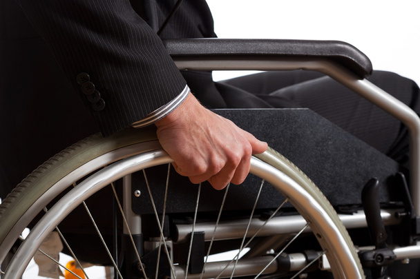 Male hand on wheel of wheelchair - Фото, изображение