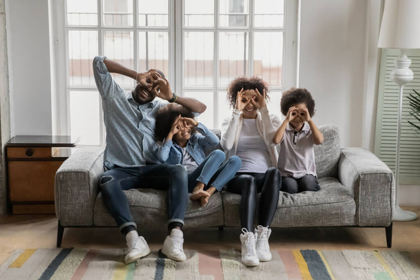 Portrait of happy millennial black couple and kids having fun - Фото, изображение